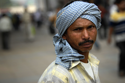 Delhi is a hot, dusty city and the combination of the two may reduce visibility in the summer, where temperatures regularly top forty degrees, as seen in this portrait of and Indian man in New Delhi. Read more about portrait photography in this archive story.